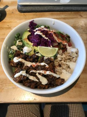 Burrito Bowl on Special, black beans, brown rice, greens, avocado, salsa & topped with Sunflower Sour cream And a lime wedge.  at Eternal Abundance in Vancouver