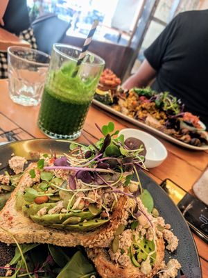The avocado and vegan feta on sourdough. Really really good! (Vegan big breakfast in the background) at Waratah Organics in Upper Ferntree Gully