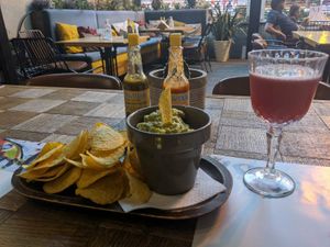 A big serve of yummy guacamole with corn chips and proper hot sauce! at Amigos in Skopje