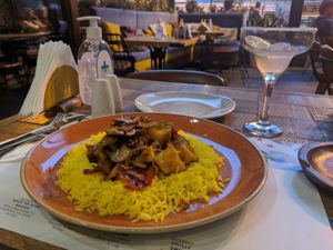 Mushroom, pepper and fresh pineapple stir-fry on yellow rice at Amigos in Skopje