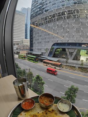 Masala oottappam and view of bus stop and UIC building at Annalakshmi Restaurant in Central Singapore