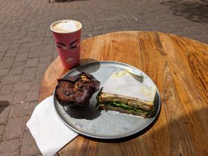 Vegan egg salad sandwich, chocolate chip/walnut muffin, and oat milk cappuccino. at Mitz Marak in Givatayim