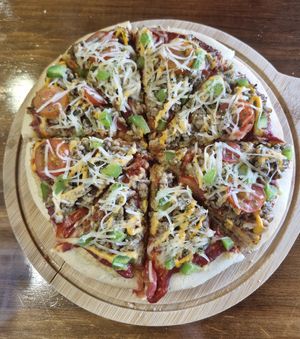 Cheezy Beefless Pizza:
Homemade cashew cream cheese, tomato sauce, vegan beef, green capsicum, cherry tomato, vegan mozzarella cheese, mix herbs. at nomVnom Bistro - Clarke Quay in Central Singapore