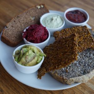 One of the Saturday breakfast options: Homemade breads: sweet loaf, raw linen seeds crackers and poppyseeds bread, all gluten-free. Homemade spreads: guacamole, beetroot pesto, macadamia cream with herbs and plum jam without sweeteners added. at Barkett in Berlin