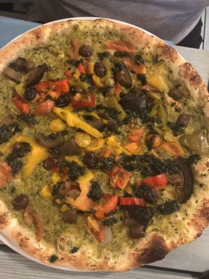 Vegan pizza with pesto sauce and veggies  at Pizzeria Capri in Jesolo