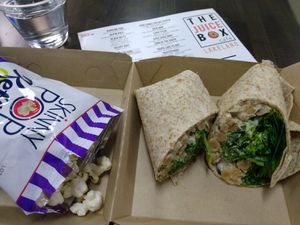 Bean Simmons chickpea "tuna" salad wrap with kale and spinach. Comes with popcorn or chips. at The Juice Box in Lakeland