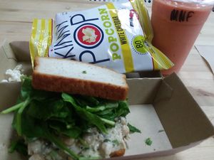 Beans Simmons chickpea sandwich on gluten-free bread, Miss new fruity smoothie, vegan popcorn at The Juice Box in Lakeland