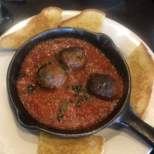Vegan meatball appetizer- tender and zesty but a bit pricey for 3 meatballs  at Busboys and Poets - Carroll St in Washington