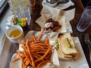 Sweet potato fries, vegan tuna sandwich, plantains with vegan sour cream, tumeric ginger tea at Busboys and Poets - Carroll St in Washington