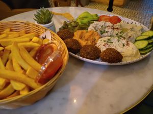 Golema plate (hummus, falafel, vegetables fresh and pickled) with fries at Mango Vegan Street Food - Bracka in Warsaw