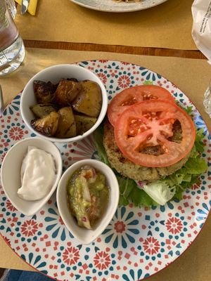 Vegan burger and baked potatoes with vegan mayo and avocado. at Quinoa in Florence