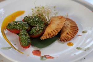 Pie stuffed with sausage, tomatoes and rucola mousse with pistachios. at Amaluna Restaurant & Lab in Punta Cana
