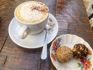 Coffee with soy-milk and bliss balls (peanut-choc, halva)  at Gugar in Valletta