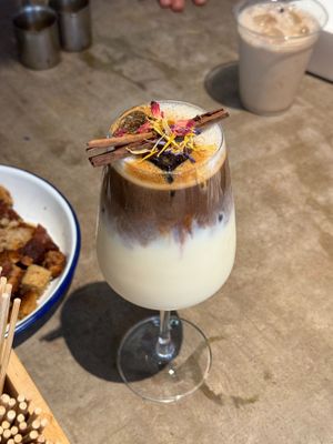 Iced Vanilla Cinnamon Latte topped with cinnamon sticks and dried flowers! at Lost Weekend in Munich