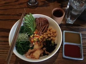 House Bibimbap: Korean style coconut rice bowl topped with seitan, avocado, green and black seaweed, chickpeas, spinach, mango salsa and kimchee, sesame and kimchee sauce. Comes with pumpkin soup appetizer.  at LuAnne's Wild Ginger in New York City