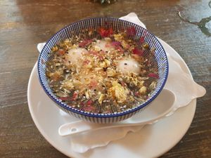 Mochi filled with sesame paste in a flower broth. Absolutely delicious! at Tianfuzius in Berlin