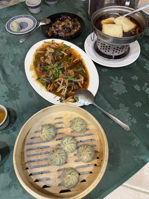 Clockwise from top: eggplant, stinky tofu, Vegan xiaolongbao (soup dumplings), and hongshao fish (fried soy sauce fish)  at Jīng Yuán SùShí Guǎn 京園素食館 in Taipei