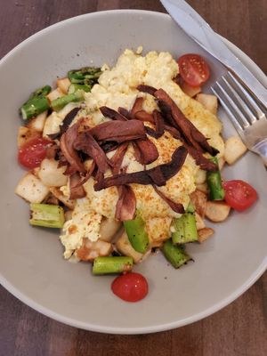 GF Benny Bowl - eggy tofu, hash brown potatoes, asparagus, oyster mushroom bacon, dreamy hollandaise sauce. sprinkled with parsley and paprika! at Naked Cafe in Kelowna