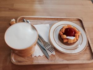 Afternoon tea perfection-mango raspberry tart and a frothy smooth ginger soymilk  at Vegan Heaven in Jiaosi