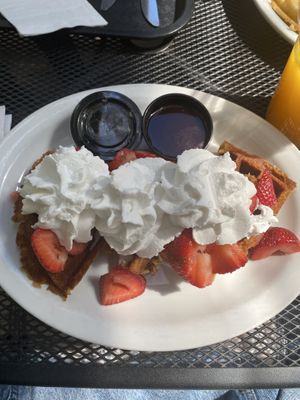 Coconut waffle with coconut whipped cream, strawberries, chocolate syrup and maple syrup. at Tia B's La Waffleria in Albuquerque