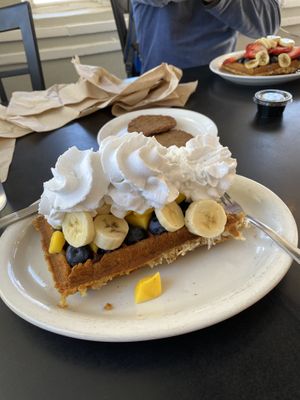 Coconut waffle with mangoes bananas and blueberries with coconut whipped cream   at Tia B's La Waffleria in Albuquerque