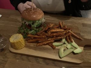 Green Goddess Burger with Soy Patty with sweet potato fries and corn on the cob   at The Vegan Bar in Malmo