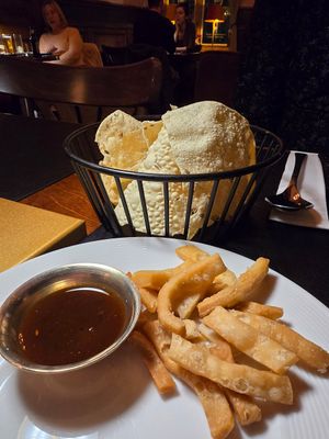 The dough sticks came as an amuse. Basket of papadams is a starter. 4,50€!! at Taj Mahal in Bruges