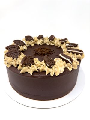 Vegan Cookies & Cream cake. Decorated with a dark chocolate glaze and cookie pieces.... you'll be in with a treat.    Attained Silver in the Free From Food Awards 2023. at The Free From Bakehouse in London