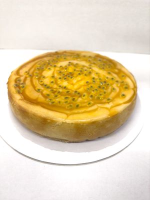 A smooth creamy texture of passion fruit puree combined with coconut cream and a vegan 'cream' cheese baked on a soft biscuit base. at The Free From Bakehouse in London