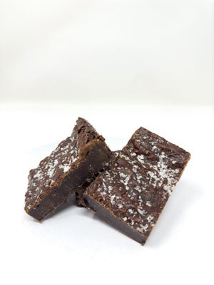 A dense slightly chewy, fudgy dark chocolate (70%) brownie, made with unrefined Muscovado sugar, and sprinkled with sea-salt flakes.  A very popular brownie with many customers. at The Free From Bakehouse in London