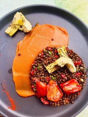 Delicious beluga lentil salad with carrot cream, grilled artichokes and tomates confit at roots in Thessaloniki
