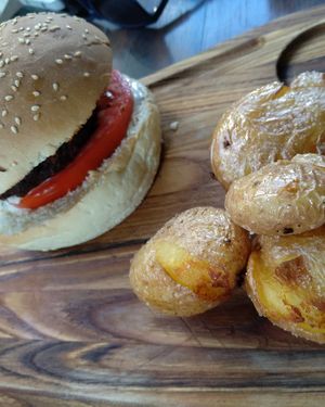 Vegan burger with black bean mushroom patty and baby potatoes at roots in Thessaloniki