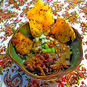 The peanut veggie heap is s pile of boiled veggies including spinach, green beans, mung-bean sprouts, sweet corn with sides of crunchy tempeh, corn cake and crisps.  at Wulan Vegetarian Warung in Ubud