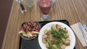 My lunch at Maran Vegan Bistro: Vegan gnocchi,Veggie sausage with sauce and Mache salad, with crudity: beans and pasta with onions :) at Maran Vegan Bistro in Vienna