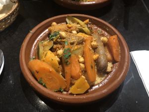 Cous cous with veg and vegan sausage  at Oranaise Cafe in Leeds