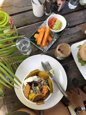 abundance bowl, ice coffee with cashew milk, sweet potato fries  at Backyard Cafe - Riverside in Phnom Penh