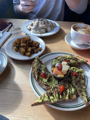 Vegan biscuits and gravy, avocado toast, and potatoes   at Redwing Cafe in Seattle