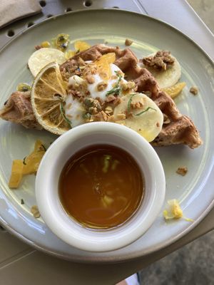 Second part of breakfast platter: single crispy waffle with syrup, passion fruit, granola, creamy something    at Berlingeri Cocina Artesanal in San Juan