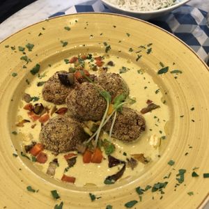 Vegan polpetta ( vegetable balls) in curry sauce with basmati rice.  at Casamadie in Cesena