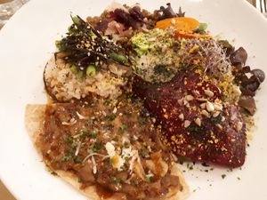 "Pizza" with onions and eggplant plus salad, rice, lentils, seaweed, sauerkraut, ... at Integral Figueres in Figueres