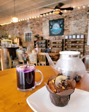 GF Vegan Banana Walnut Muffin topped with Espresso Chocolate, Toasted Walnuts, and Brandied Pear. Served with Butterfly Pea Tea. at The Bee's Knees in Augusta