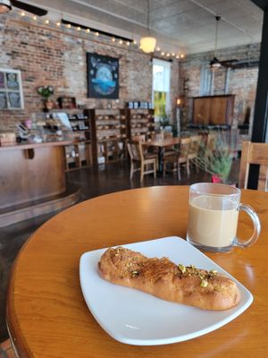 Vanilla Cream Stuffed Eclair topped with Burnt Honey and Toasted Pistachios. at The Bee's Knees in Augusta