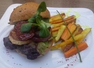 Amazing tofu burger (marinated tofu, dried tomatoes, lettuce, arugula, red onion, dijon mustard) with turnip-carrots fries at Green Spirit in Prague