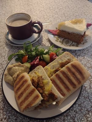 Tofu & vegan cheese ciabatta, soyamilk latte, & salted caramel apple cake. at The Cornerhouse Cafe in Berwick-upon-tweed