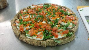 LOVJuice Raw Live Pizza- Almond Crust, Casher Cheese with Fresh Basil, Cilantro and Tomato Toppings. at LOVJuice in Boca Raton