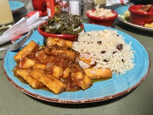 Brown stew tofu with collards, rice and peas, and Caribbean slaw  at Red Stripes Caribbean Cuisine and Lounge in Bluffton