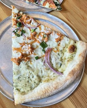 Vegan Buffalo 666: Shredded Buffalo Jackfruit, Follow Your Heart Vegan "Mozzarella," Red Onions, fresh Green Onions, Vegan Ranch and Wing Sauce  at Sizzle Pie - W Burnside in Portland