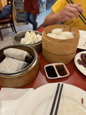 To the left sticky rice wrapped in lotus leaf, the middle being Char sui Bao, and the right is vegan shrimp dumplings   at Bodhi Kosher Vegetarian Restaurant in New York City