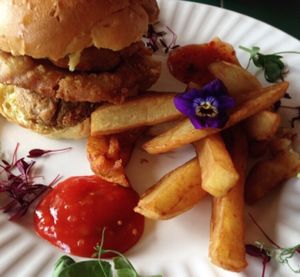 Vegan burger and chips with cute editable flowers at Super Natural in Newcastle Upon Tyne