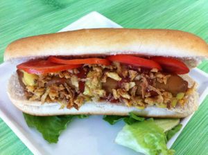Vegan hot dog with tomato, lettuce and fried onion at Gandhi Veggie in Barcelona